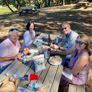 a group of people sitting at a picnic table