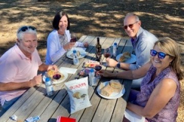 a group of people sitting at a picnic table