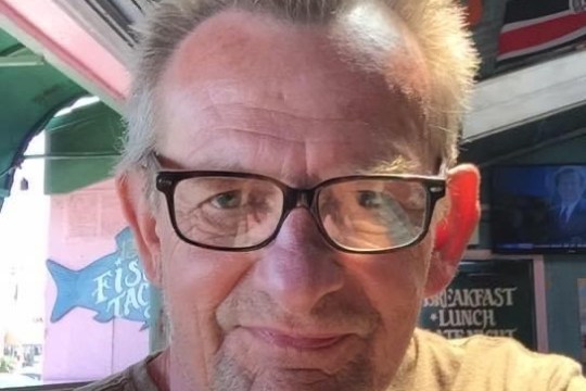 a close up of a man in glasses looking at the camera