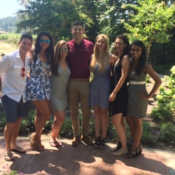 a group of people standing next to a tree